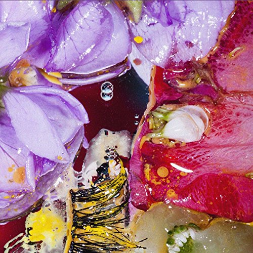 Close-up of colorful, abstract floral arrangement with a vinyl record label.