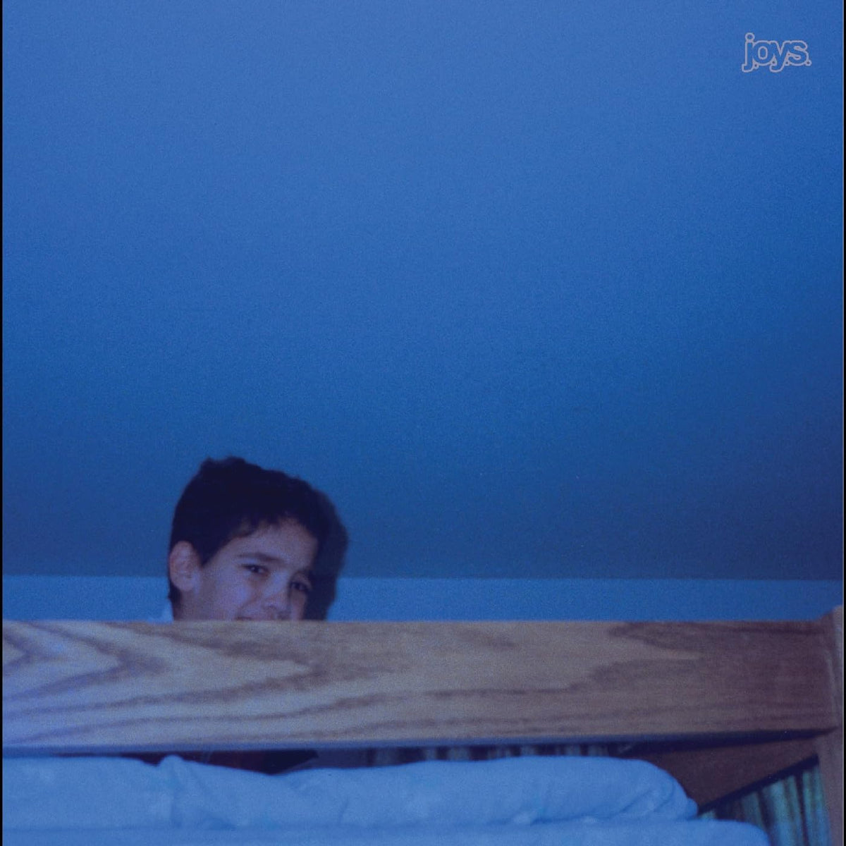 Blue album cover featuring a person partially hidden under a blanket.