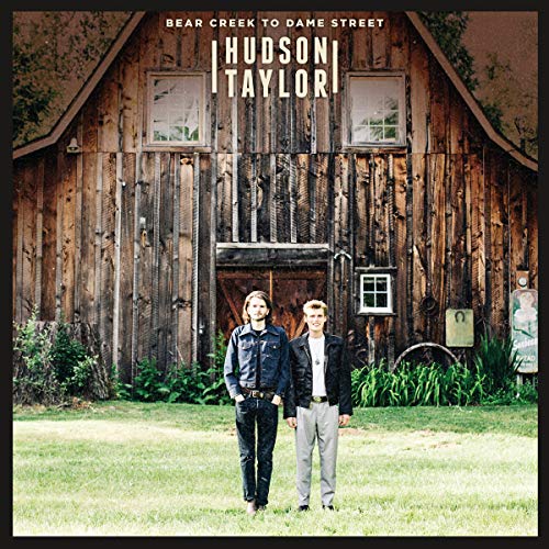 CD cover: two men stand in front of a weathered wooden barn.