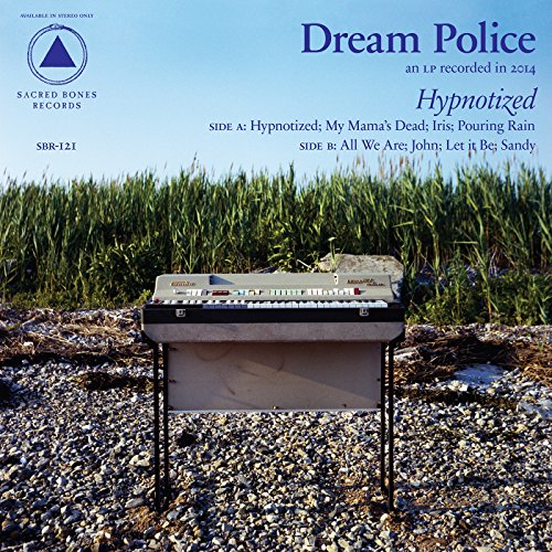 CD cover: Dream Police - Hypnotized, featuring a keyboard in a field.