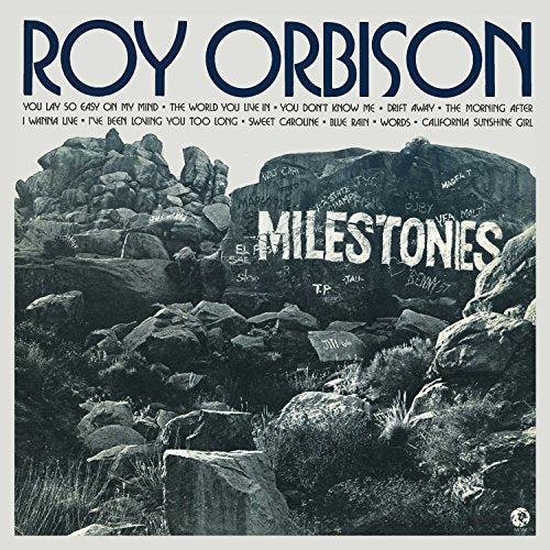 Roy Orbison’s “Milestones” vinyl album cover with rocky landscape and graffiti.