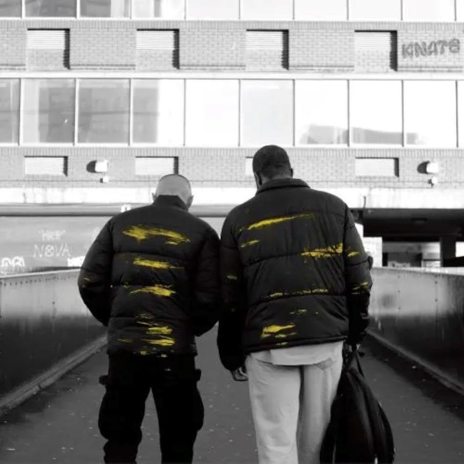 Two figures seen from behind walking under a bridge, album cover.