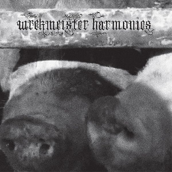 Black and white album cover with textured, distorted imagery and ornate text.