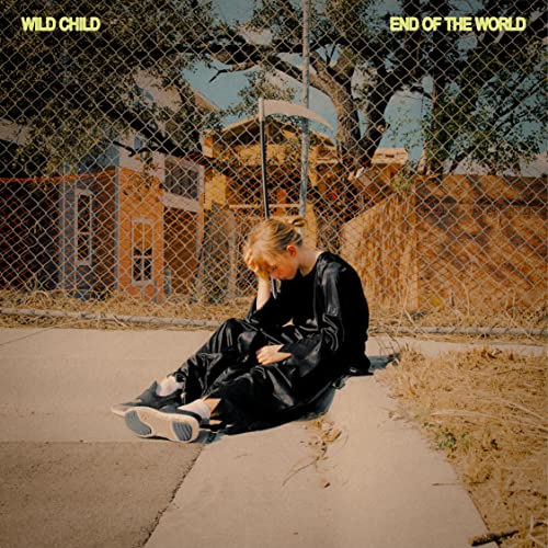 Album cover: person sitting against a building with a chain-link fence.