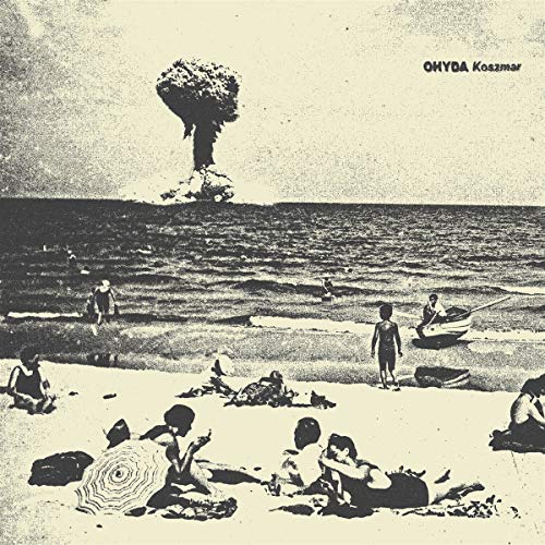 Beach scene with people, a boat, and a distant mushroom cloud.