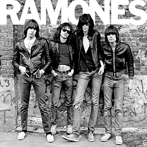 Black and white photo of the Ramones band members posing in front of a brick wall.