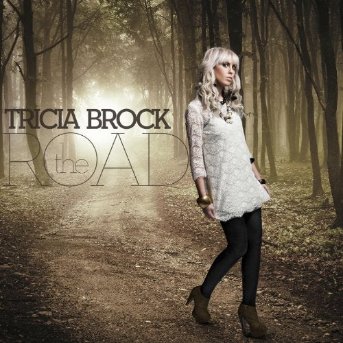 Album cover for Tricia Brock’s “Road” featuring a woman in a forest.