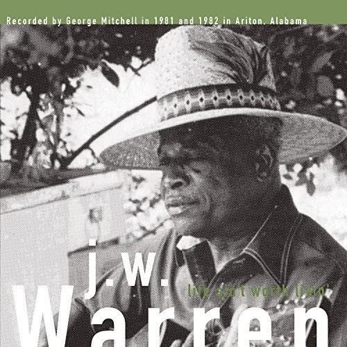 Black and white portrait of J.W. Warren wearing a straw hat.