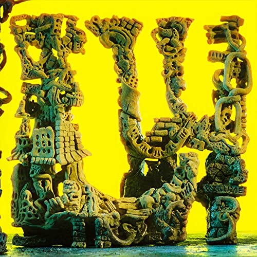 Yellow album cover featuring a complex, sculpted tower of forms.