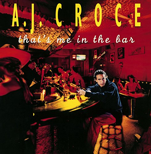 A man sits at a dimly lit bar with red lighting in this album cover.