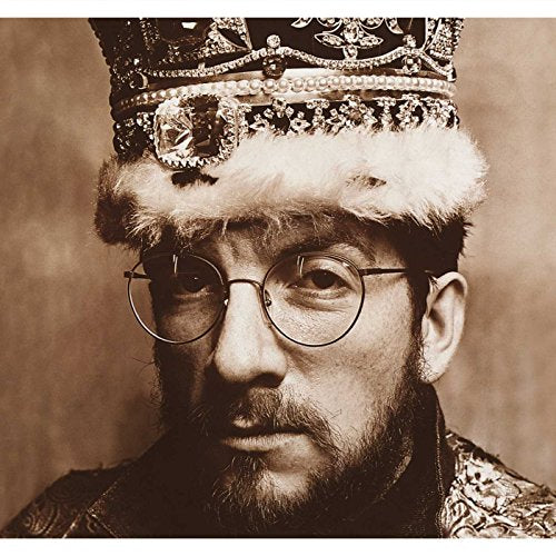Close-up of Elvis Costello wearing glasses and a jeweled crown.