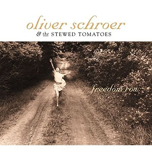 CD cover: a person jumping on a dirt road through trees.