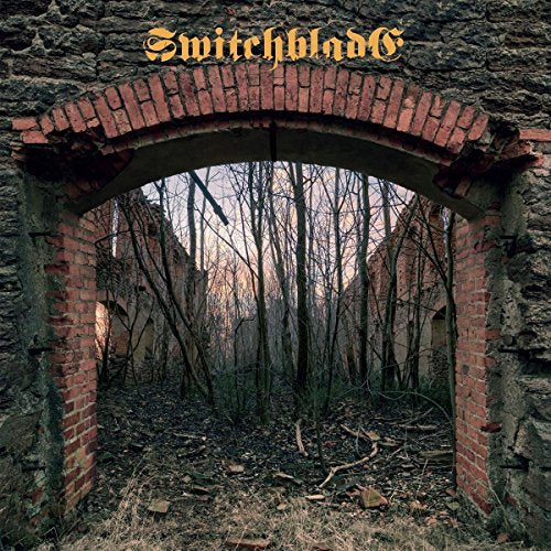 Brick archway framing a desolate winter forest scene, album cover.