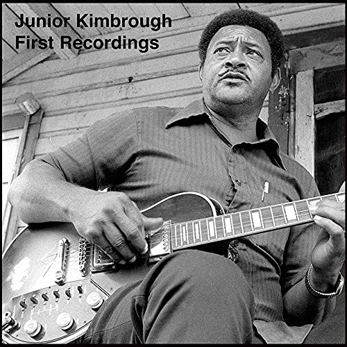 Black and white photo of a man playing an electric guitar.