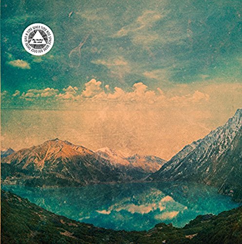 CD cover with mountains, lake, and a circular logo at the top.