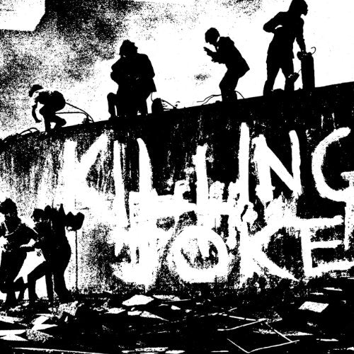High-contrast black and white image of silhouettes standing on a wall with graffiti text.