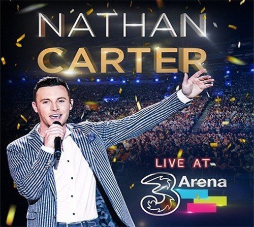 Nathan Carter performing on stage with a microphone before a large crowd.