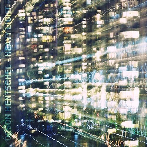 Blurred, abstract city lights and building facade with album title text.