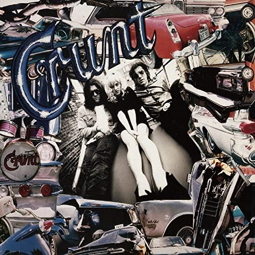 Album cover for “Crunt” featuring a band amidst crushed cars.