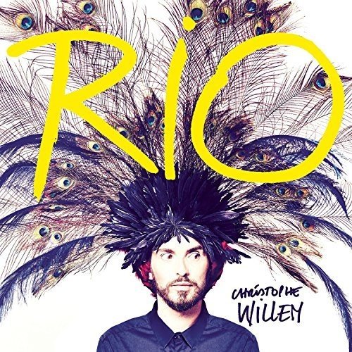 CD cover with man wearing peacock feathers, bold yellow "RIO" text.