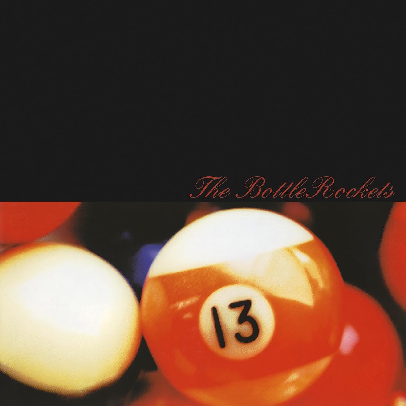 Vinyl record cover with red text and a blurred image of billiard balls.