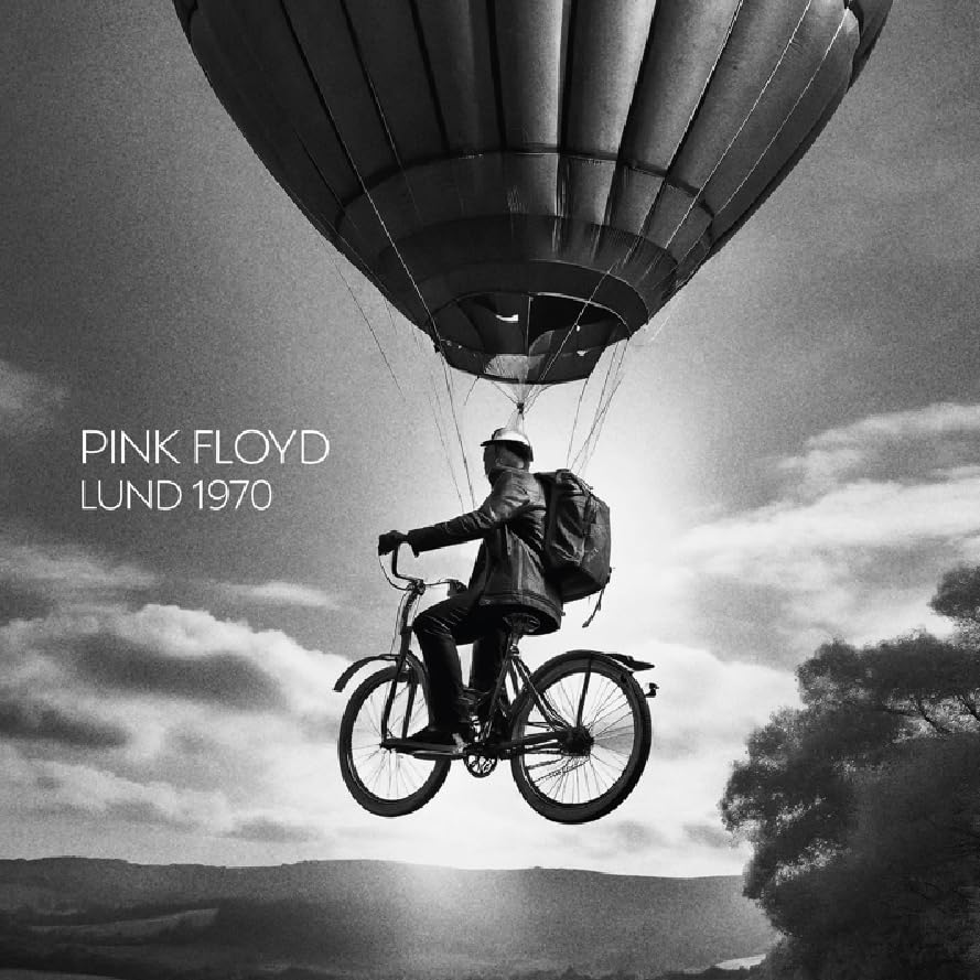 Black and white album cover: man on bicycle suspended by a balloon.