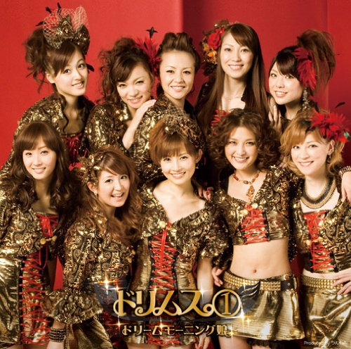 Group of women in gold outfits with red floral headpieces.