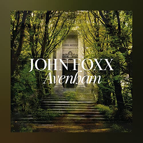 CD cover for John Foxx’s “Avenham” featuring a stone monument in trees.