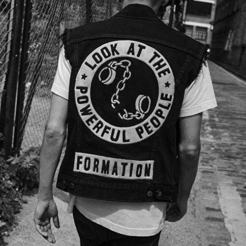 CD cover: person wearing a vest with a circular design.