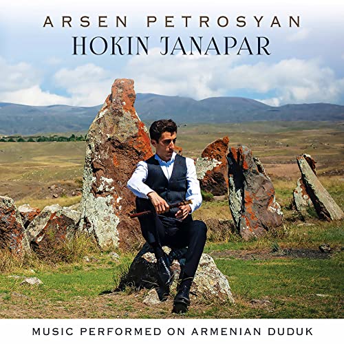 CD cover: man playing duduk among ancient stone formations.