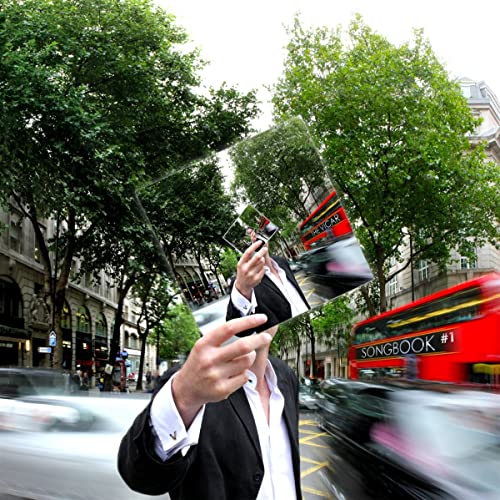 CD case held up against a blurred London street scene.