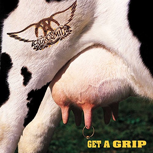 A cow udder with a gold piercing and the Aerosmith logo on its flank.