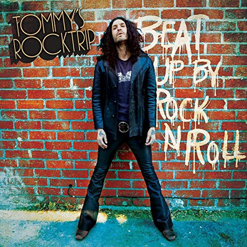 Album cover: man with long hair leaning against a brick wall.