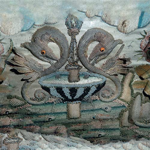 Intricate sculpture of a dolphin fountain with textured, aquatic base.