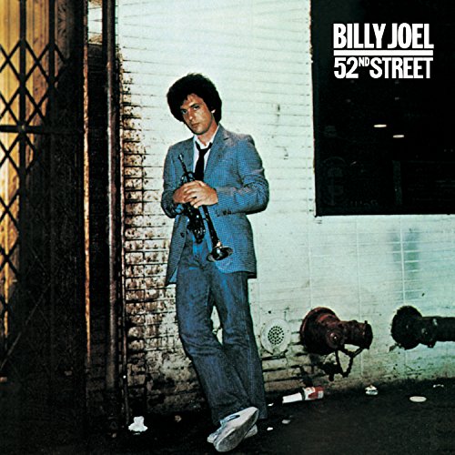 Billy Joel album cover: man with saxophone in a city alley.