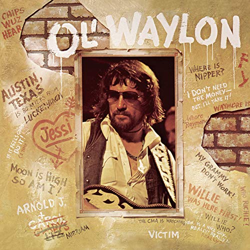 Waylon Jennings album cover: portrait in a painted brick frame with graffiti.