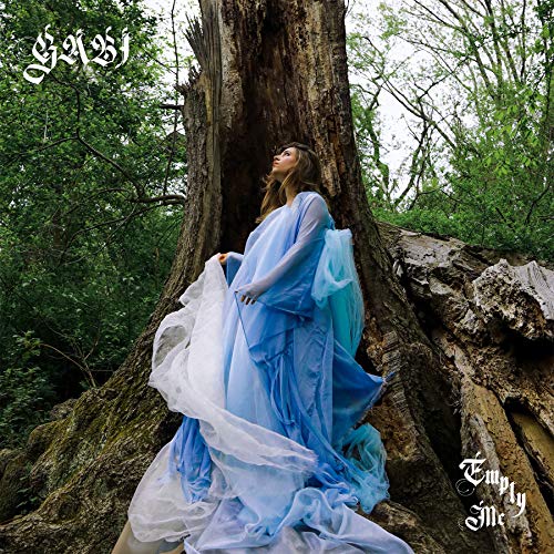 Album cover: woman in blue dress by a large tree.