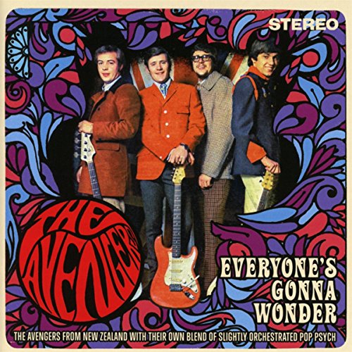Four band members stand against a psychedelic patterned background with guitars and album text.