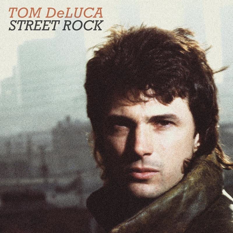 CD cover featuring a portrait of Tom DeLuca with a city backdrop.