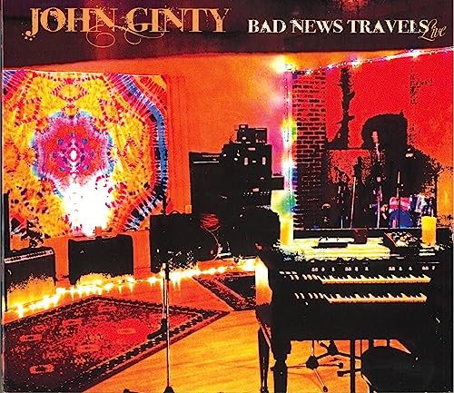 CD cover for John Ginty’s “Bad News Travels: Live” with stage imagery.