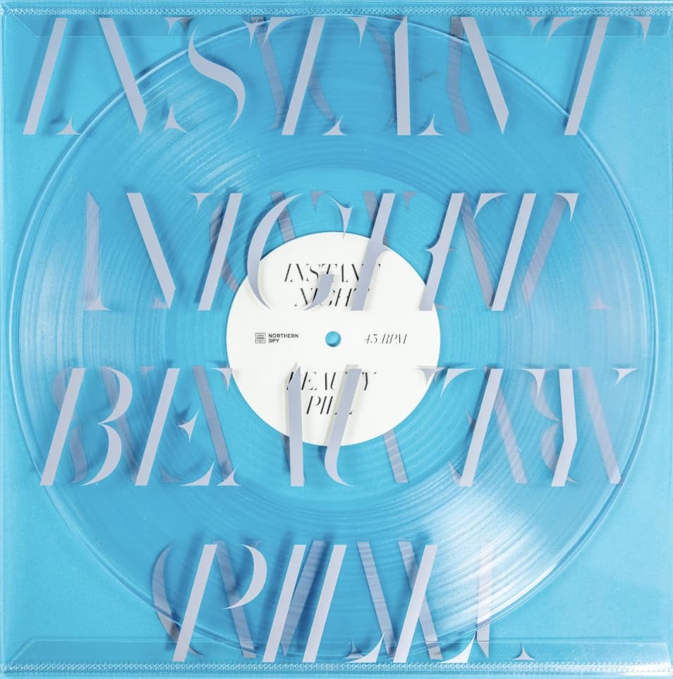Clear vinyl record with blue text reading "Beauty Pill - Instant Night".