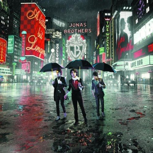 Jonas Brothers album cover, three men with umbrellas in a city.