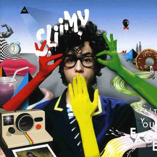 CD cover with a man in a suit surrounded by colorful objects.