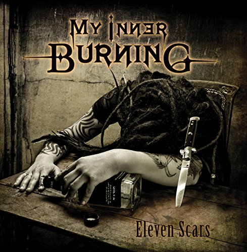 Album cover for My Inner Burning's Eleven Scars featuring a tattooed person's arms.