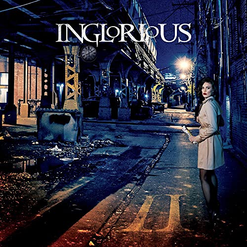 A woman in a trench coat stands on a dark city street at night.