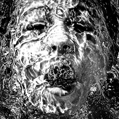 Black and white portrait of a man’s face distorted by water.