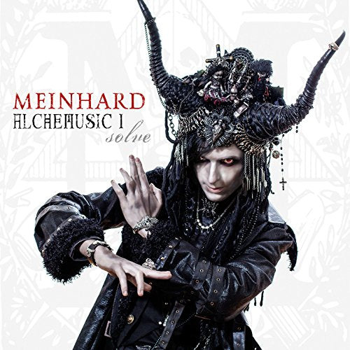 CD cover: Man in elaborate black headdress and coat, gesturing.
