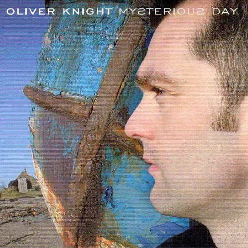 CD cover featuring a man’s profile and abstract blue and brown textures.