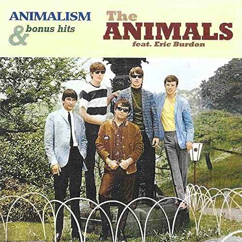 The Animals band members posing in front of a garden statue.