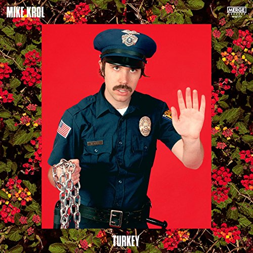 Vinyl album cover: Man in police uniform against red background with flowers.